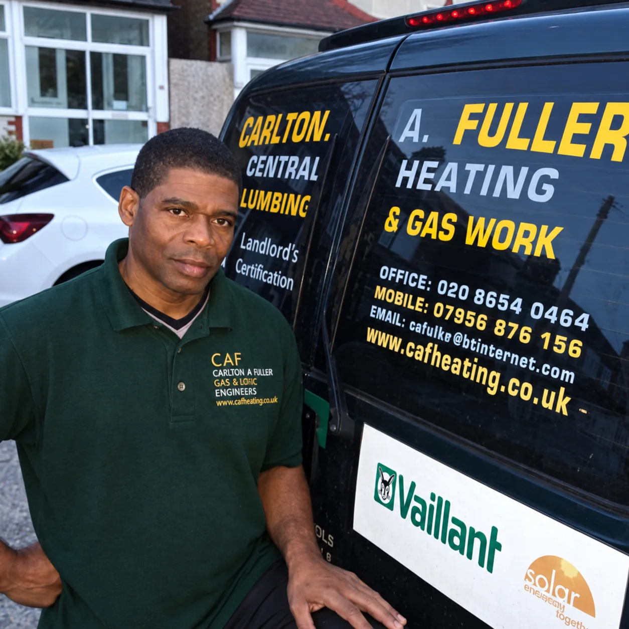 Carlton Fuller beside the CAF Heating van, wearing his green work polo